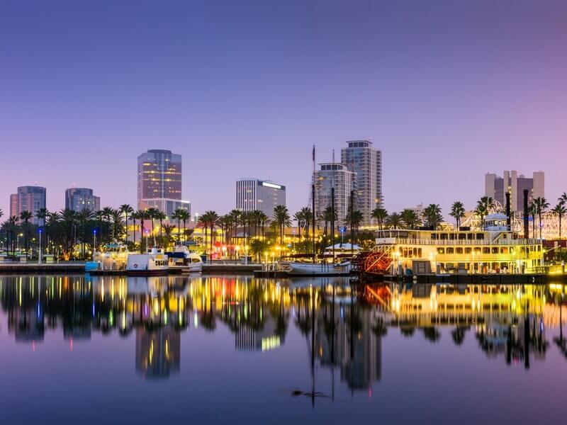 Downtown Long Beach waterfront with city skyline and local businesses at dusk, highlighting the vibrant business community in Long Beach, California.