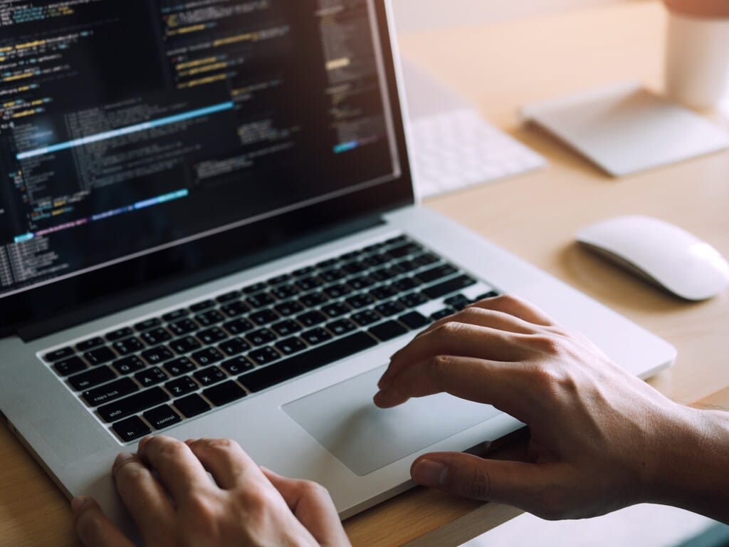 Technical code on a laptop as part of website maintenance work.