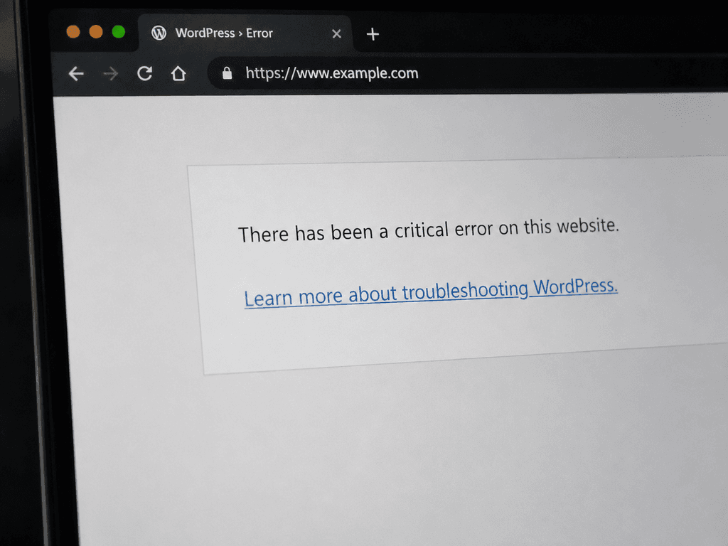 WordPress critical error message displayed on a laptop during website troubleshooting
