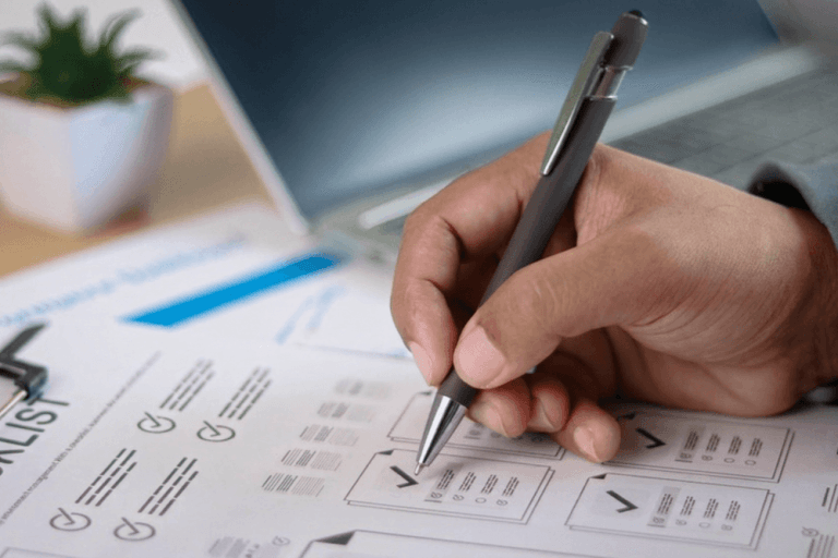 Business owner reviewing website project checklist and approval documents