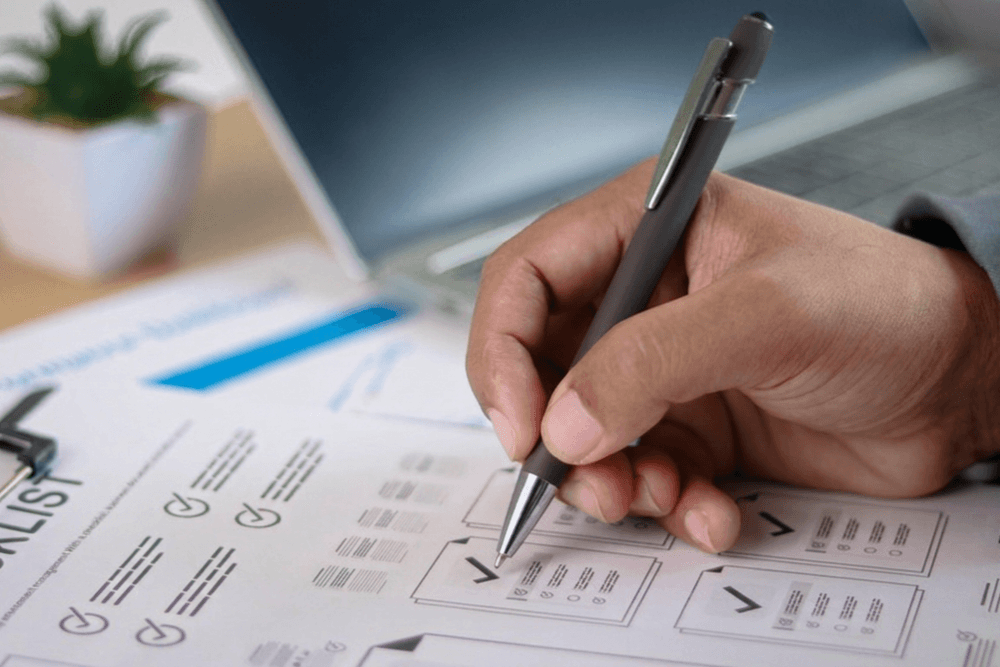Business owner reviewing website project checklist and approval documents